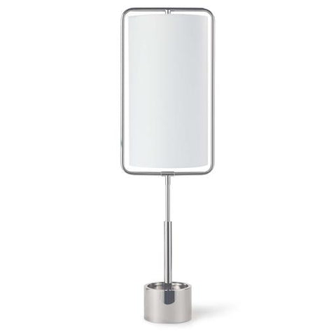 Isolated image of a table lamp with silver finishings. The tall, narrow lampshade is frames with metal bars.