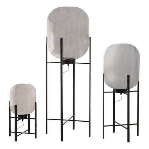 An isolate image of three lamps in various sizes. Black metal frames with a large vintage glass mercury covering. 