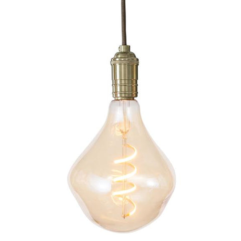 Isolated image of a light bulb with a warm, coiled filament and an irregular teardrop bulb.