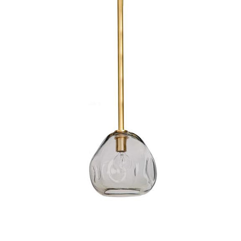 An isolated image of a single pendant light encased in an irregularly-shaped glass bowl